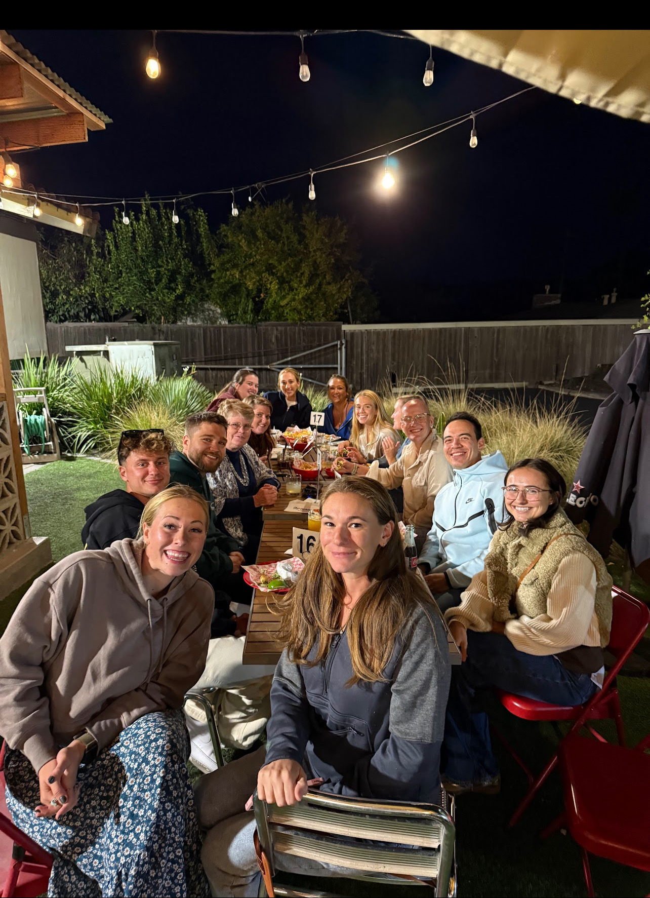 SSU instructors at group dinner under string lights