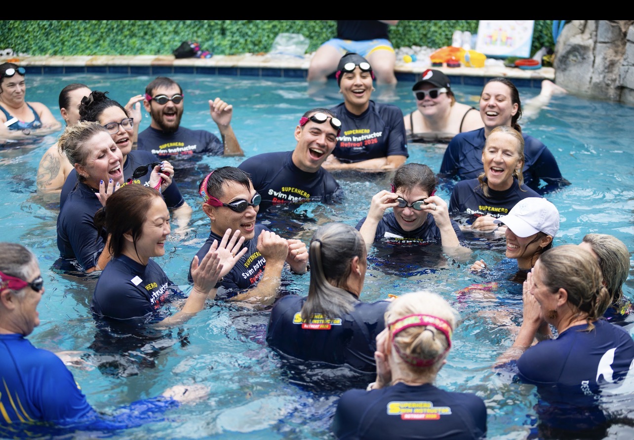SSU instructors celebrating together in the pool at a past workshop
